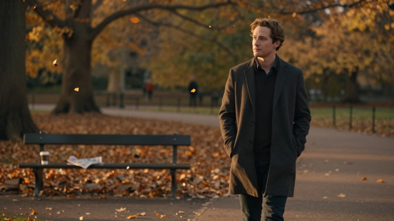 A man walks alone through Hyde Park at sunset, surrounded by falling leaves, lost in quiet thought.